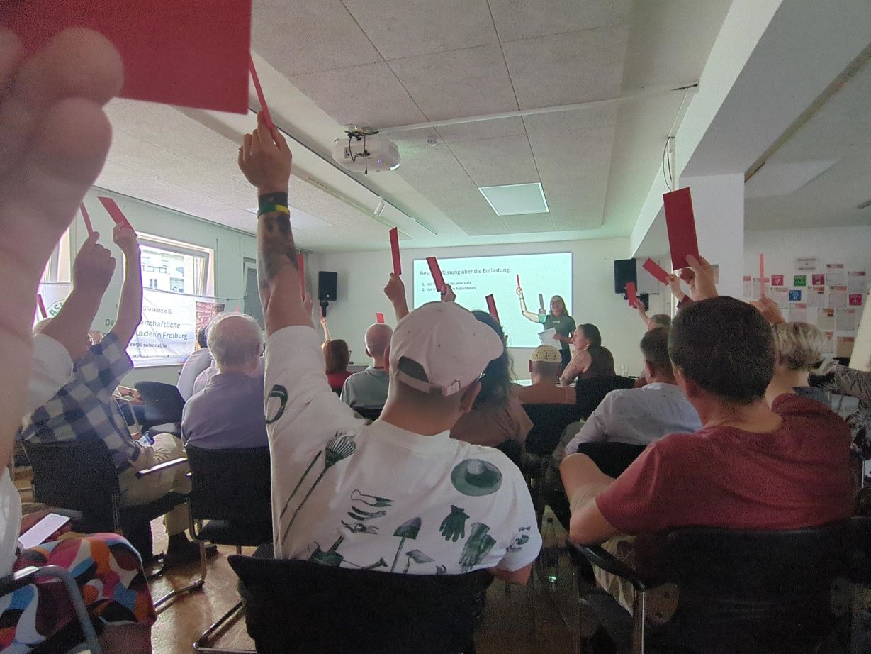 People raising their hands during a presentation
