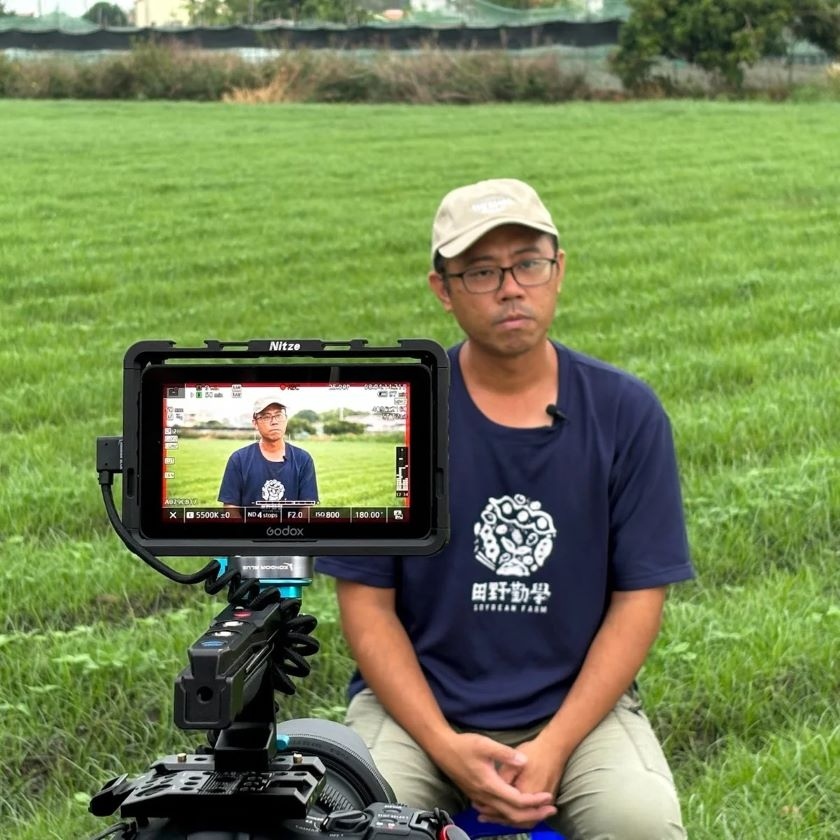 The image shows a camera filming Mr. Kuang-Ching Chen, founder of "Taiwan Soybean Farmer"