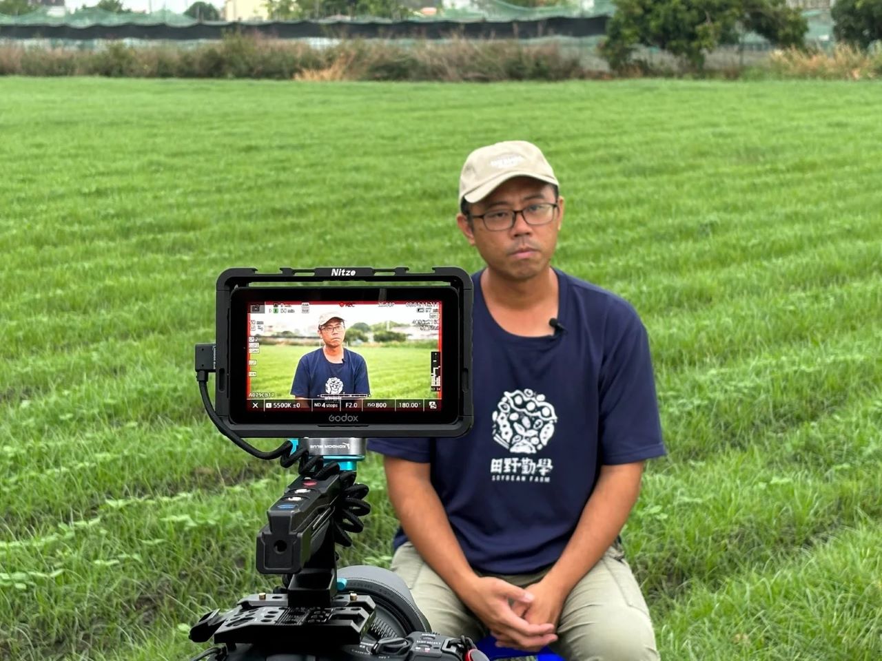 The image shows a camera filming Mr. Kuang-Ching Chen, founder of "Taiwan Soybean Farmer"