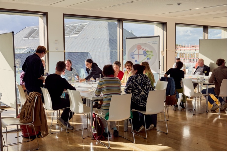 Many people are sitting at tables and talking