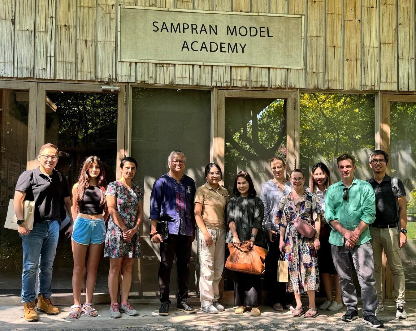 group of people standing in front of sampran Model academy